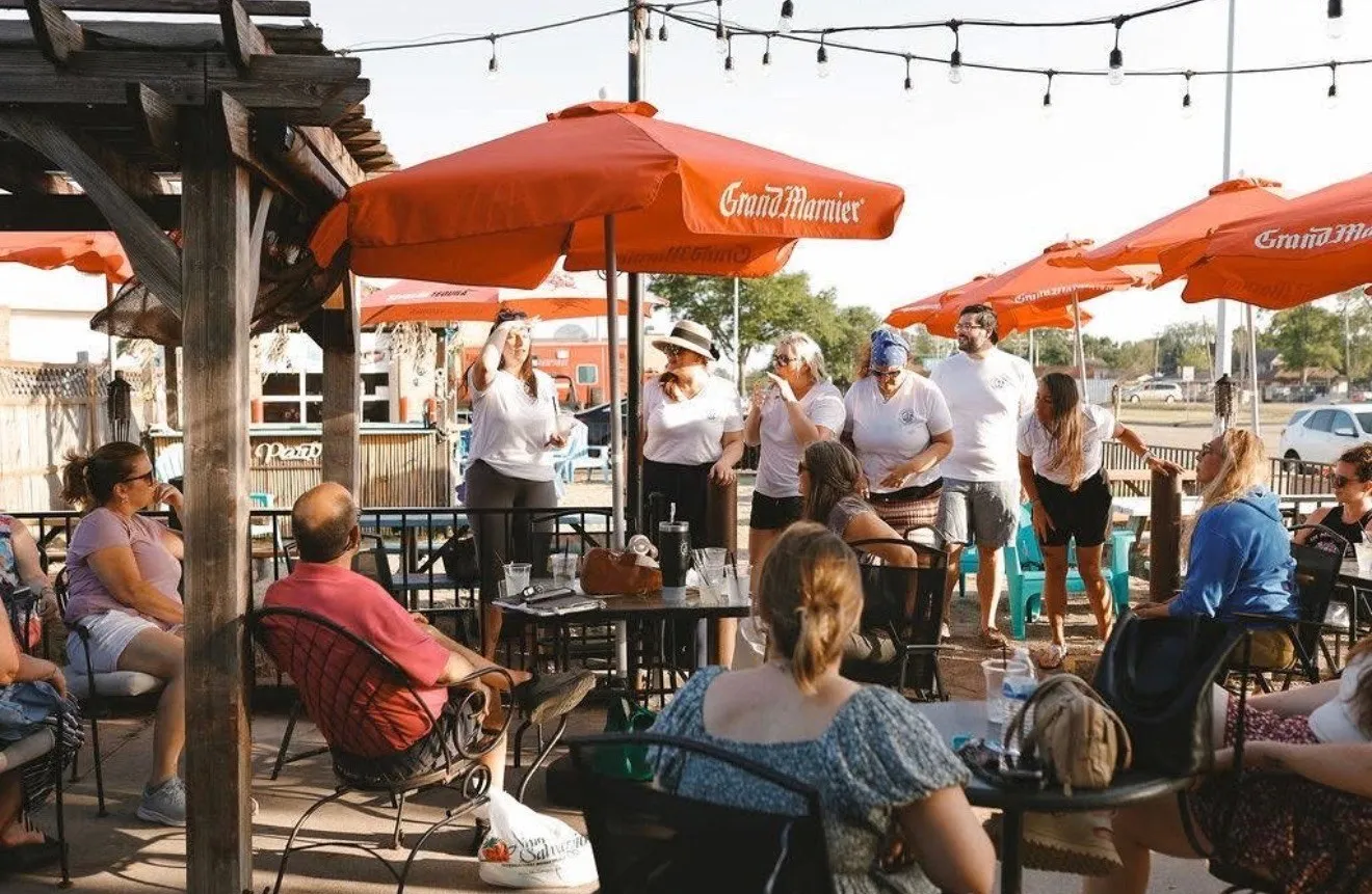 Chamber board members speaking to guests on a patio at the Preview Event