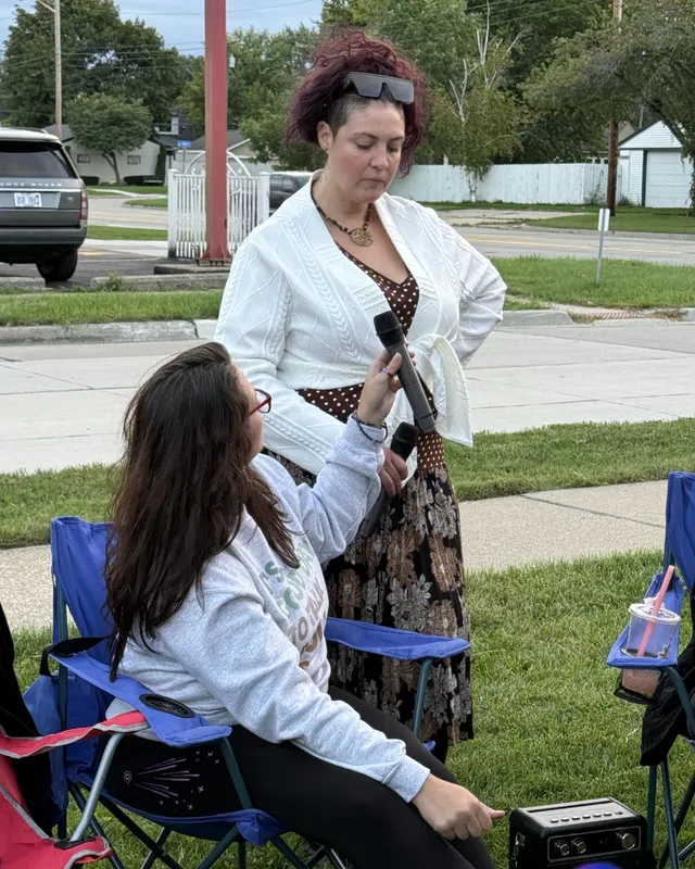 A member speaking into a microphone at an outdoor chamber meetup