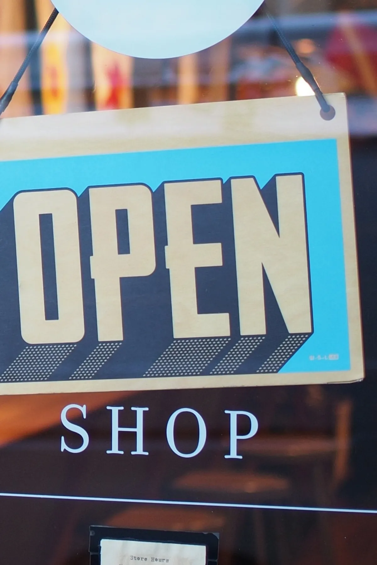 An Open sign hanging in a shop door